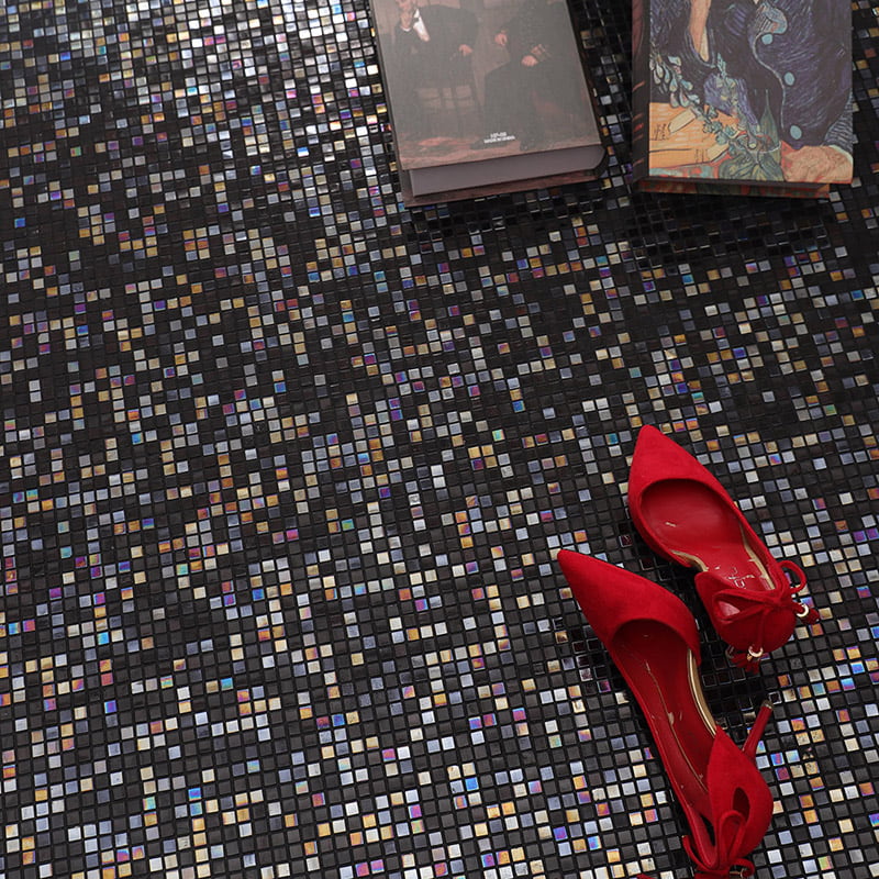 Small mosaic floor tiles in black with iridescent finish and red high heels