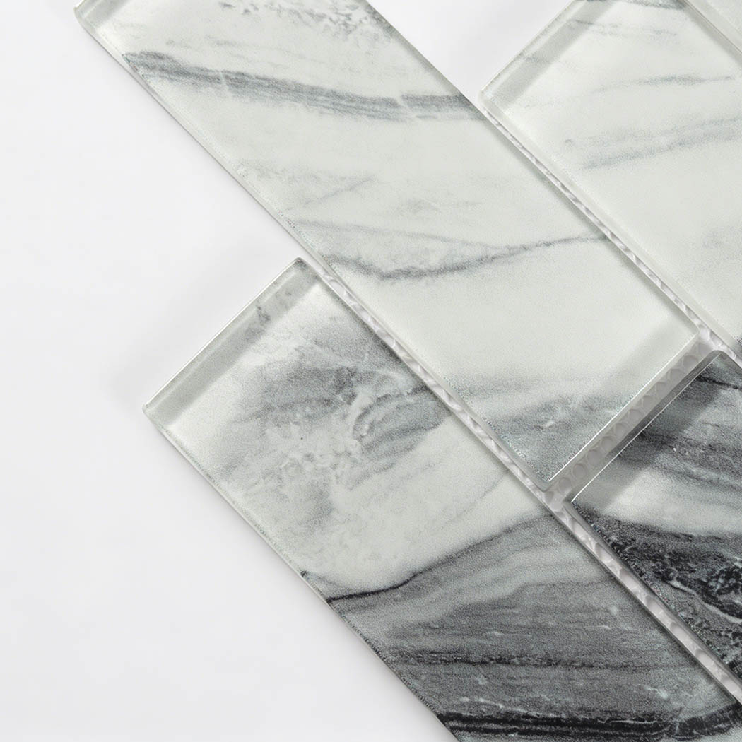 Diagonal glass subway tile crop with smoky gray marble bands