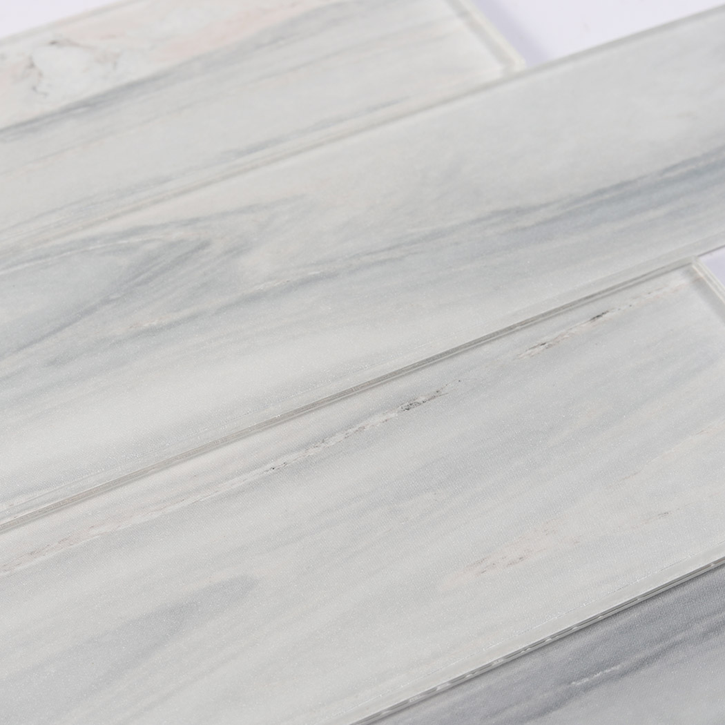 Detailed look at the smooth polished glass surface with a wavy grey marble pattern.