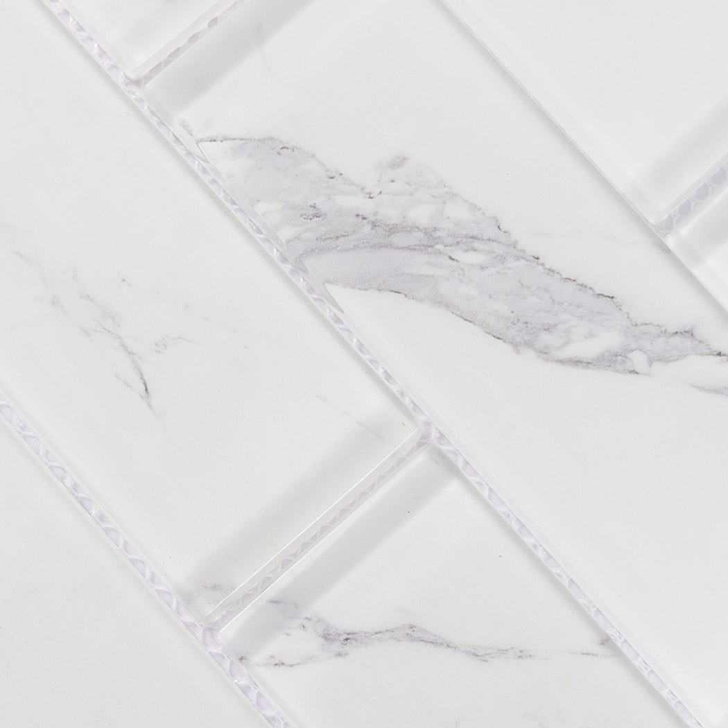 White glass subway tile surface with soft gray marble veins and beveled edges