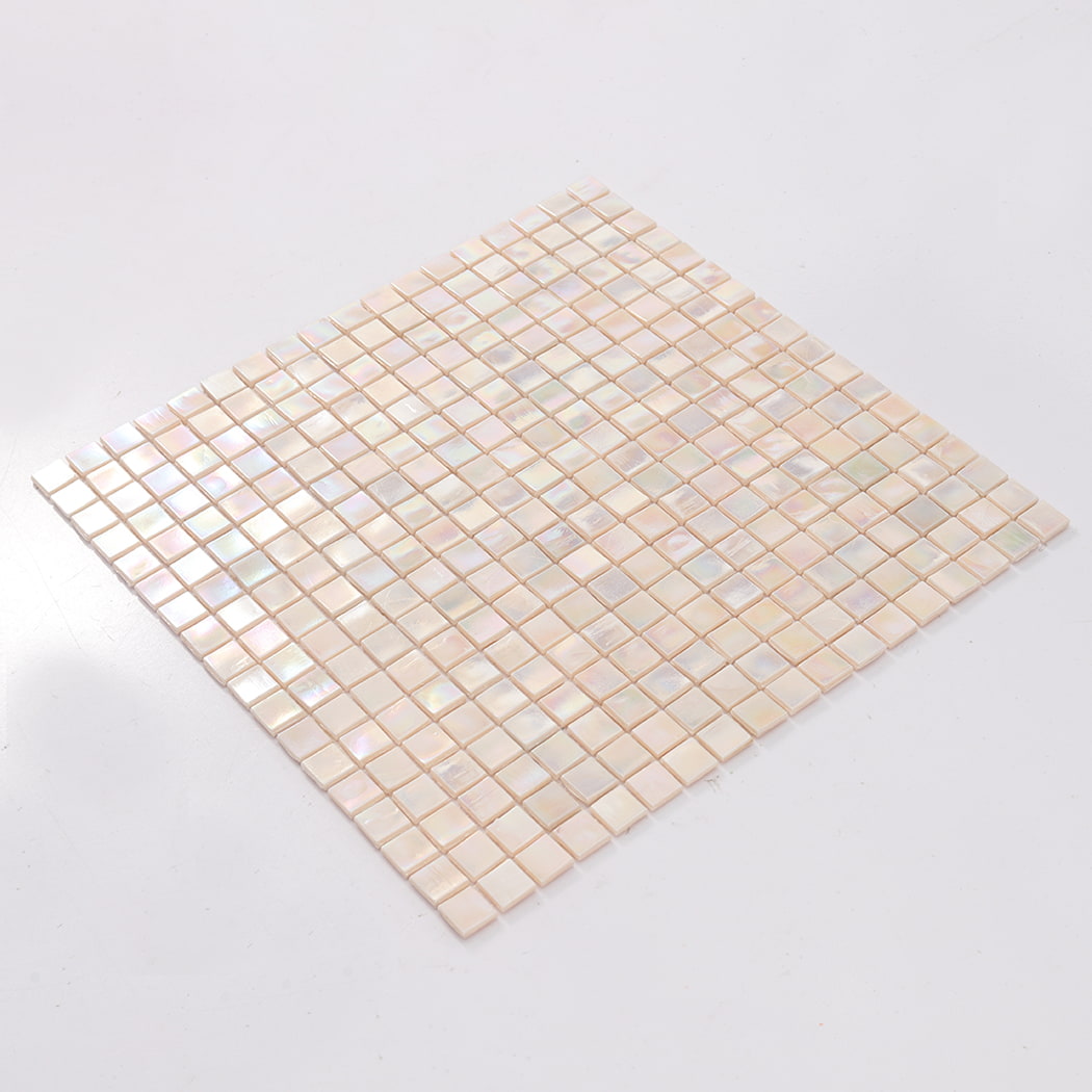 Angled view of a full soft pink iridescent square glass mosaic tile sheet