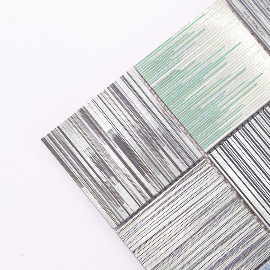 Close-up of square aluminum linear textured mosaic tile corner details