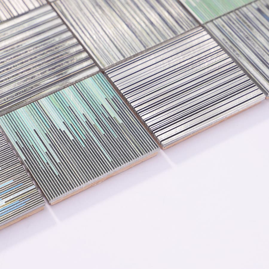 Close-up of square aluminum linear textured mosaic tile edge details