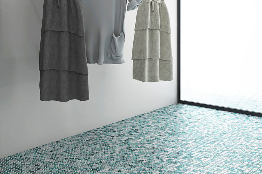 Green glass mosaic square floor tiles in a modern interior space