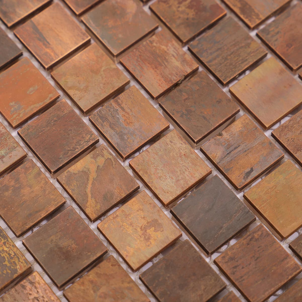 Close-up of rustic copper mosaic squares with textured patina