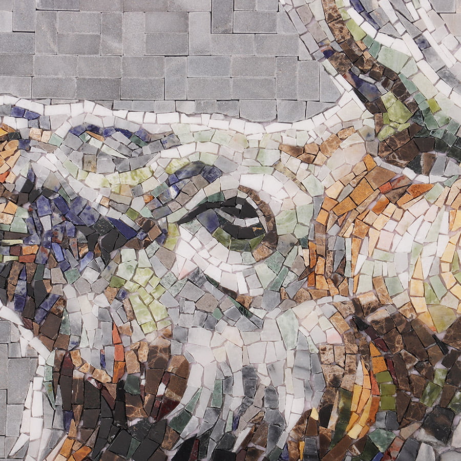 Detailed view of the stag’s eye and antler base crafted from multicolored mosaic pieces.