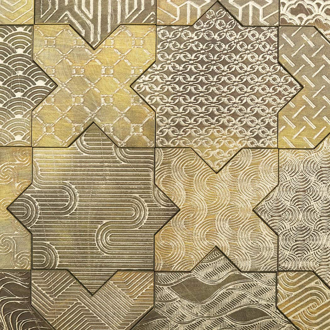 Macro texture detail of patterned gold star cross aluminum mosaic