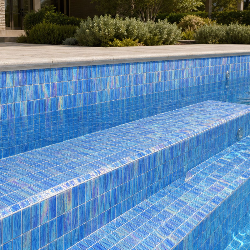 Sunlit blue 1x2 glass mosaic pool bench with shimmering water