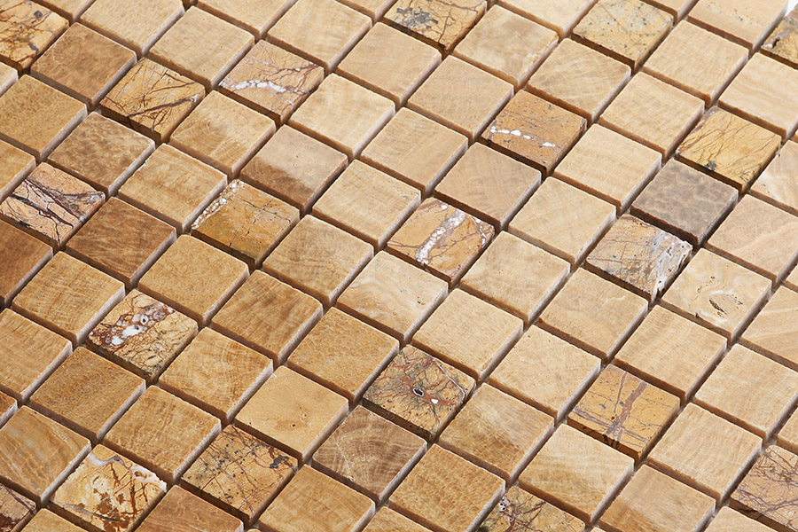 Square tan tile bathroom mosaic made of honed natural stone for shower floors.