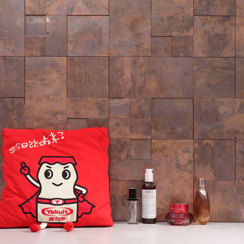 Brown copper metal tiles with brushed texture on wall