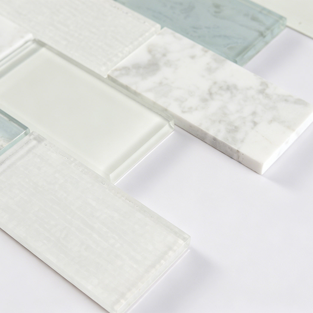 Close view of textured glass, blue glass and marble subway mosaic tiles