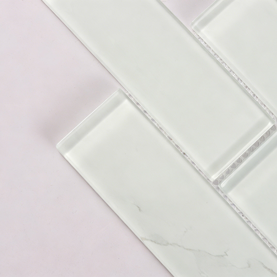 Translucent white glass subway tile with subtle gray vein and beveled edge