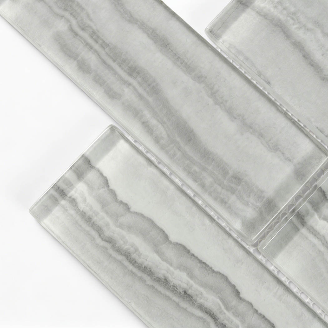 Translucent glass subway tile sample with gray layered stone bands