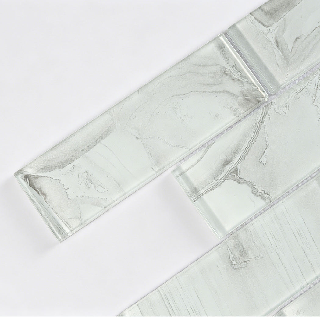 Translucent white gray glass subway tile with marble veins and beveled edges