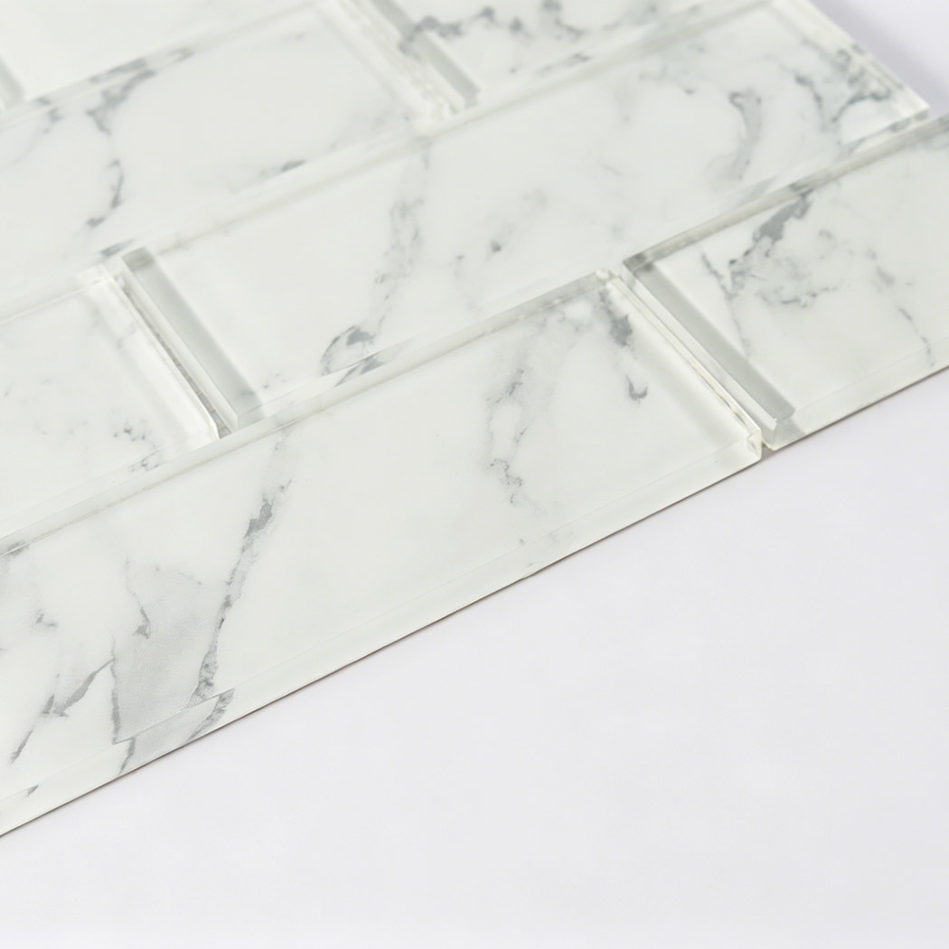 White marble look glass subway tile showing glossy bevels and gray veins