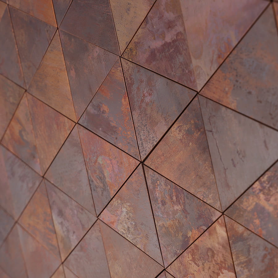 Close-up of installed triangle copper metal mosaic tile wall