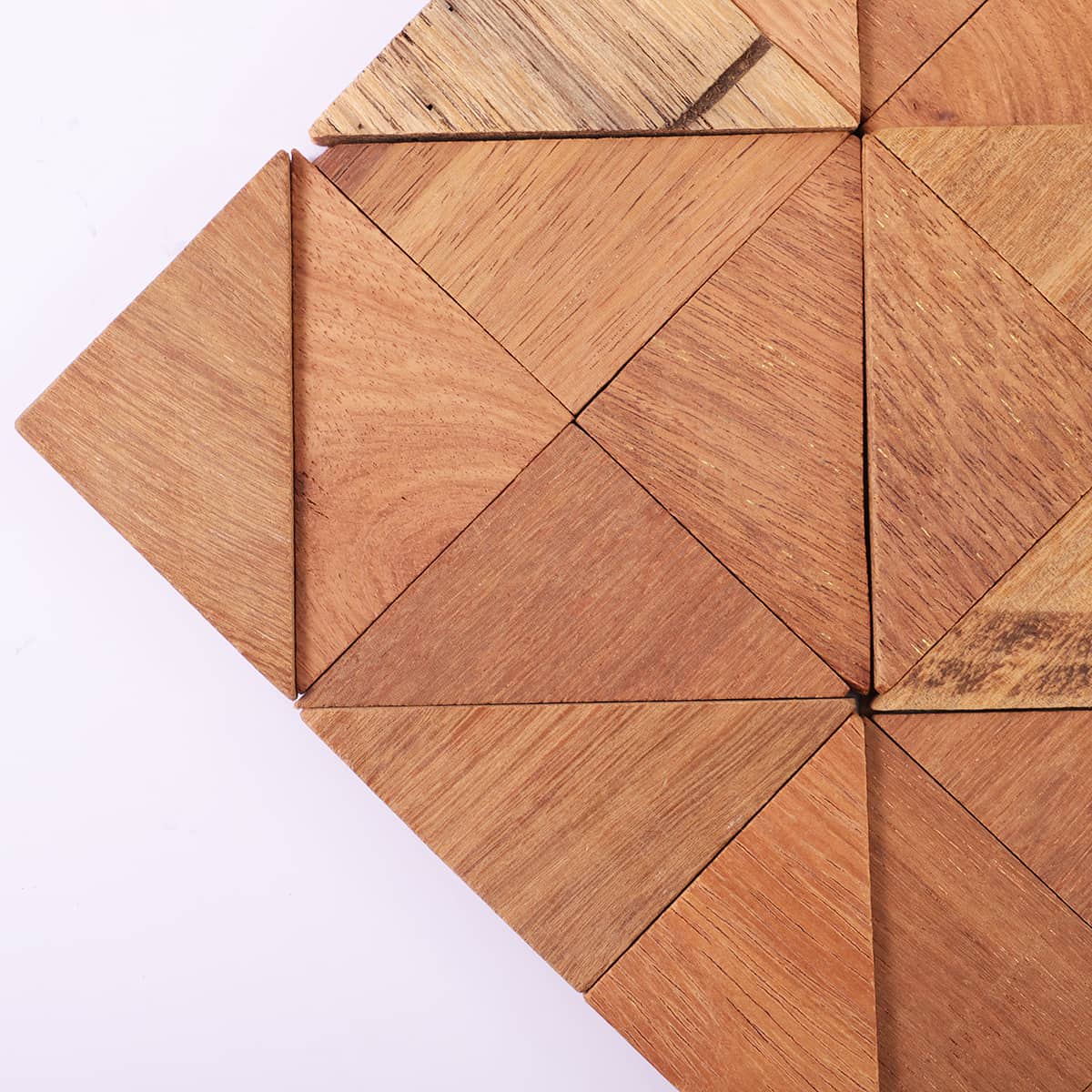 Corner close-up of triangle wood tiles with clean joint lines