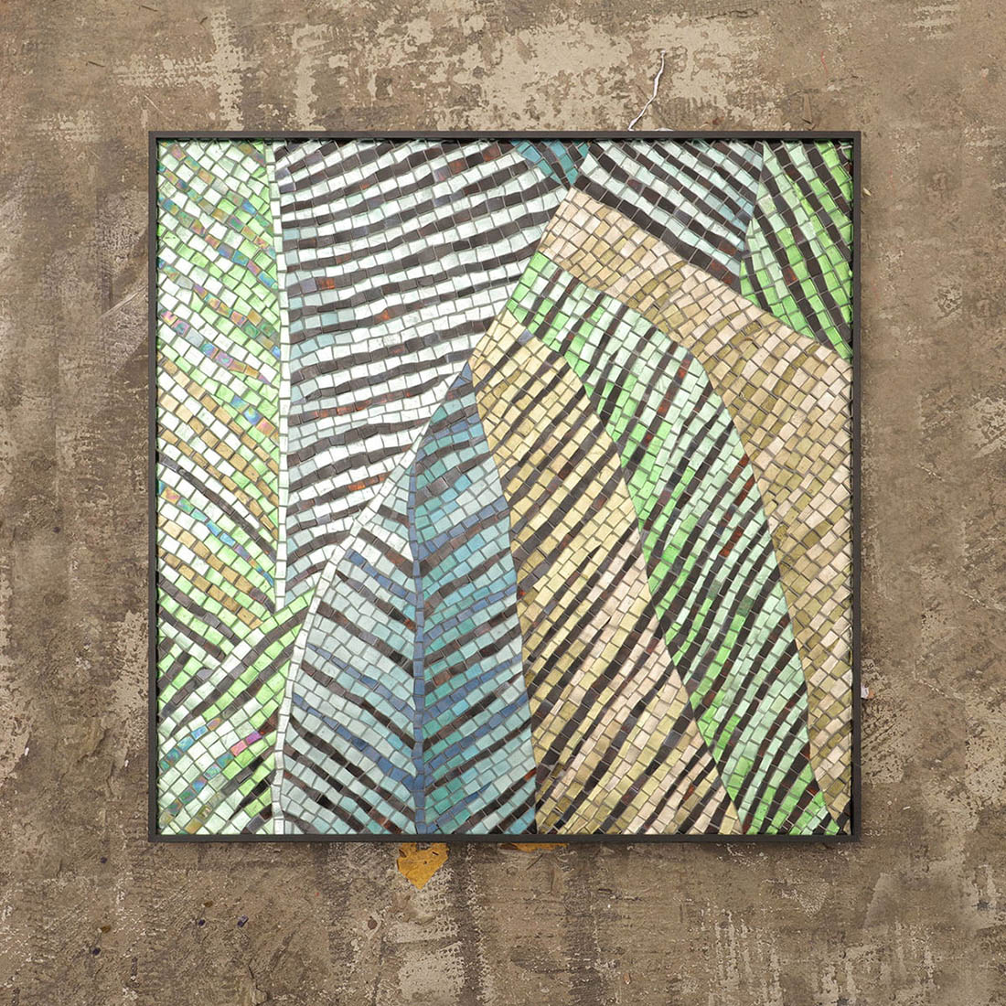 Front view of tropical leaf mosaic featuring yellow and green leaves