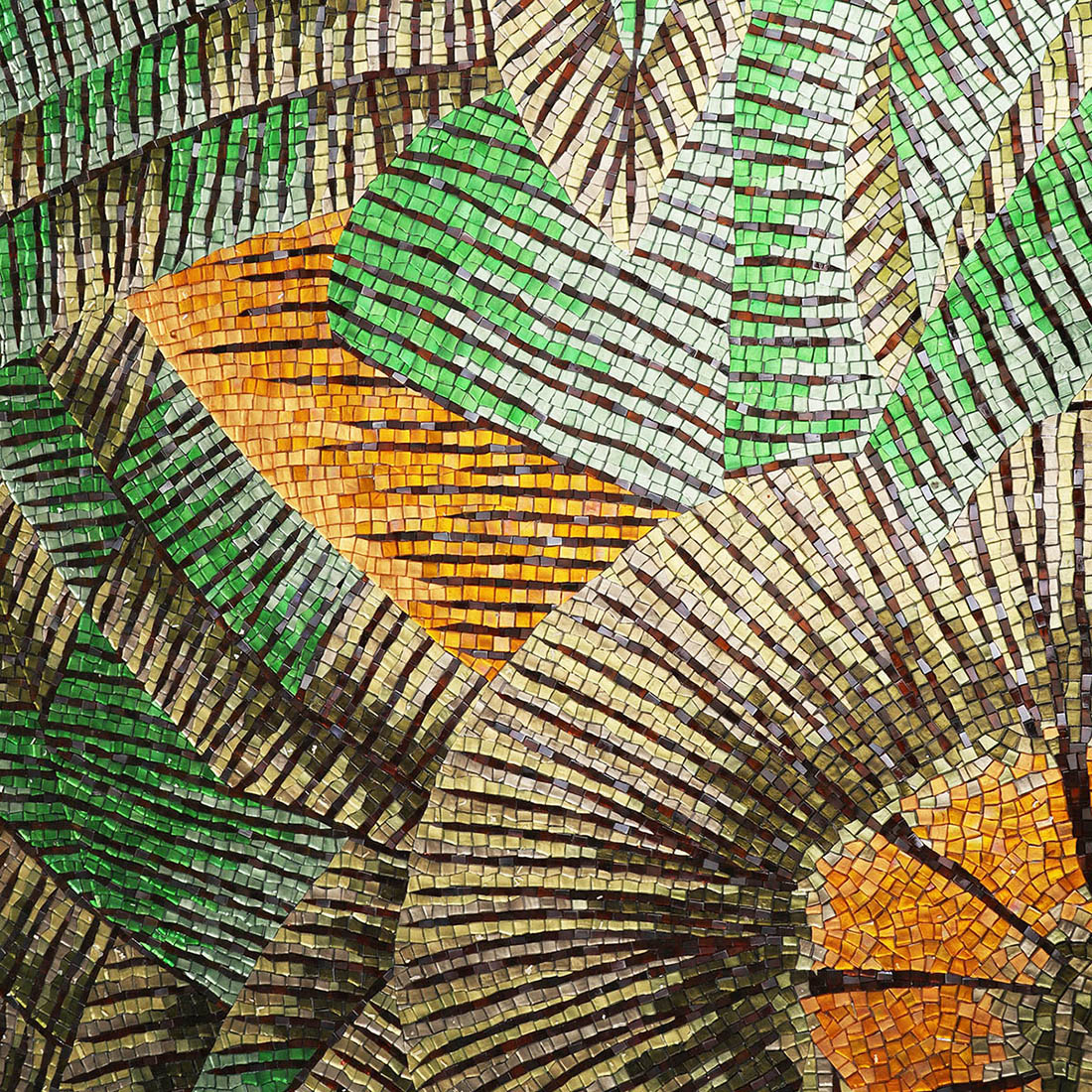 Close-up view of tropical green and brown leaves in mosaic with orange highlights