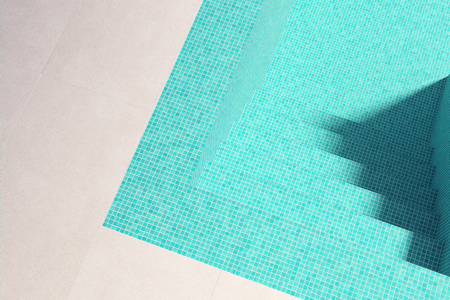 Turquoise swimming pool tiles creating a clean modern look with geometric pool steps