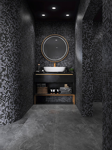 Vertical view of bathroom with grey black mosaic wall and stone tile floor