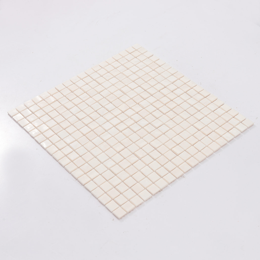 Angled view of a full very light pink square glass mosaic tile sheet