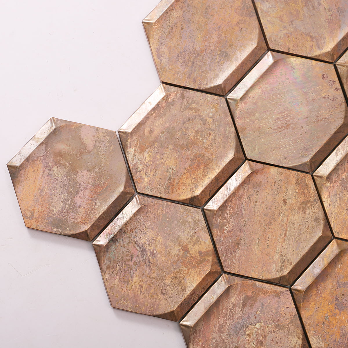  Close-up of vintage bronze hexagon mosaic tiles showcasing textured surface and patina