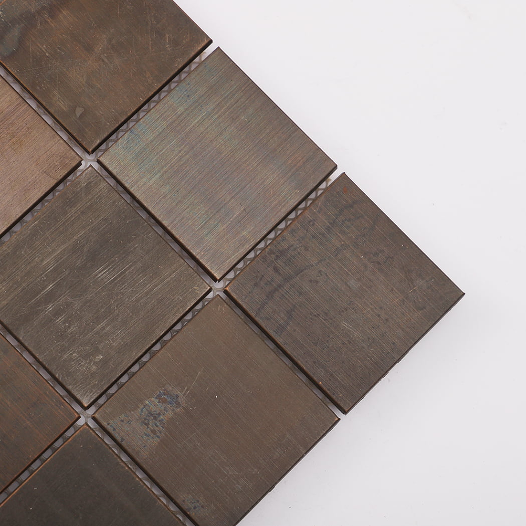 Corner close-up of vintage copper square mosaic tile showing natural patina.