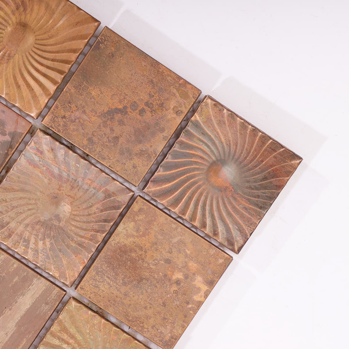 Close-up of swirl embossed copper tiles from top right corner