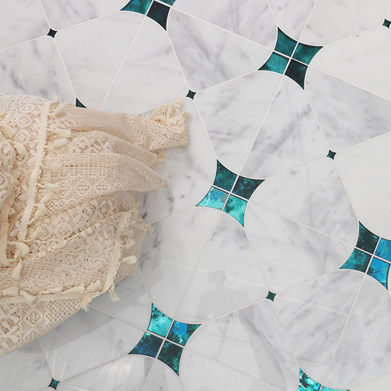White marble waterjet tile with blue accent details and geometric pattern