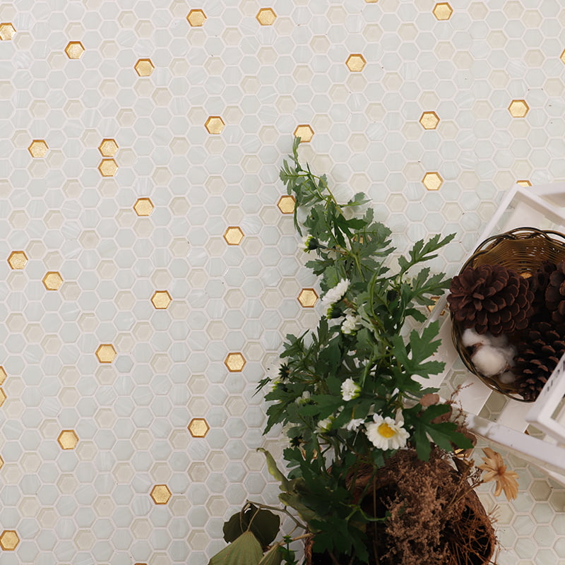 Close-up of white and gold hexagon mosaic tiles, showcasing intricate glass and gold detailing