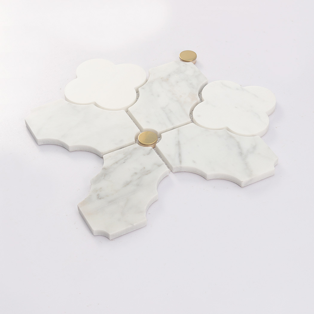 Angled view of white arabesque marble mosaic tile showing raised stone edges