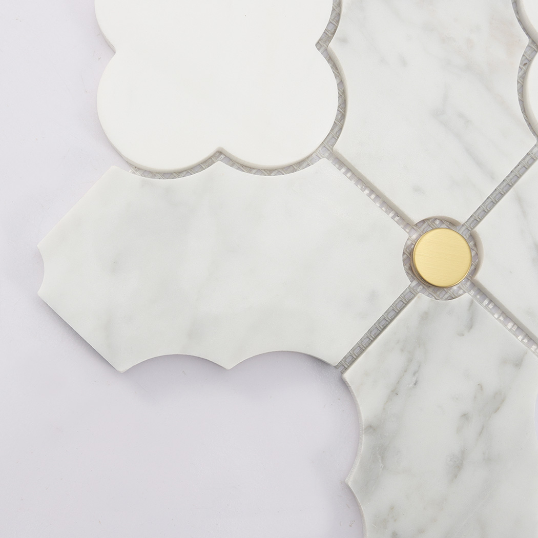 Corner detail of white arabesque marble mosaic tile with gold round insert