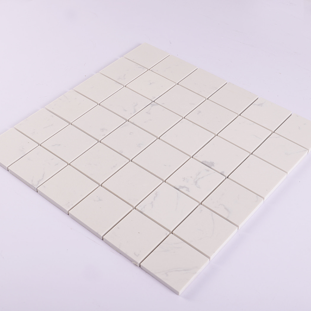 Angled perspective of white engineered marble square mosaic tile sheet.