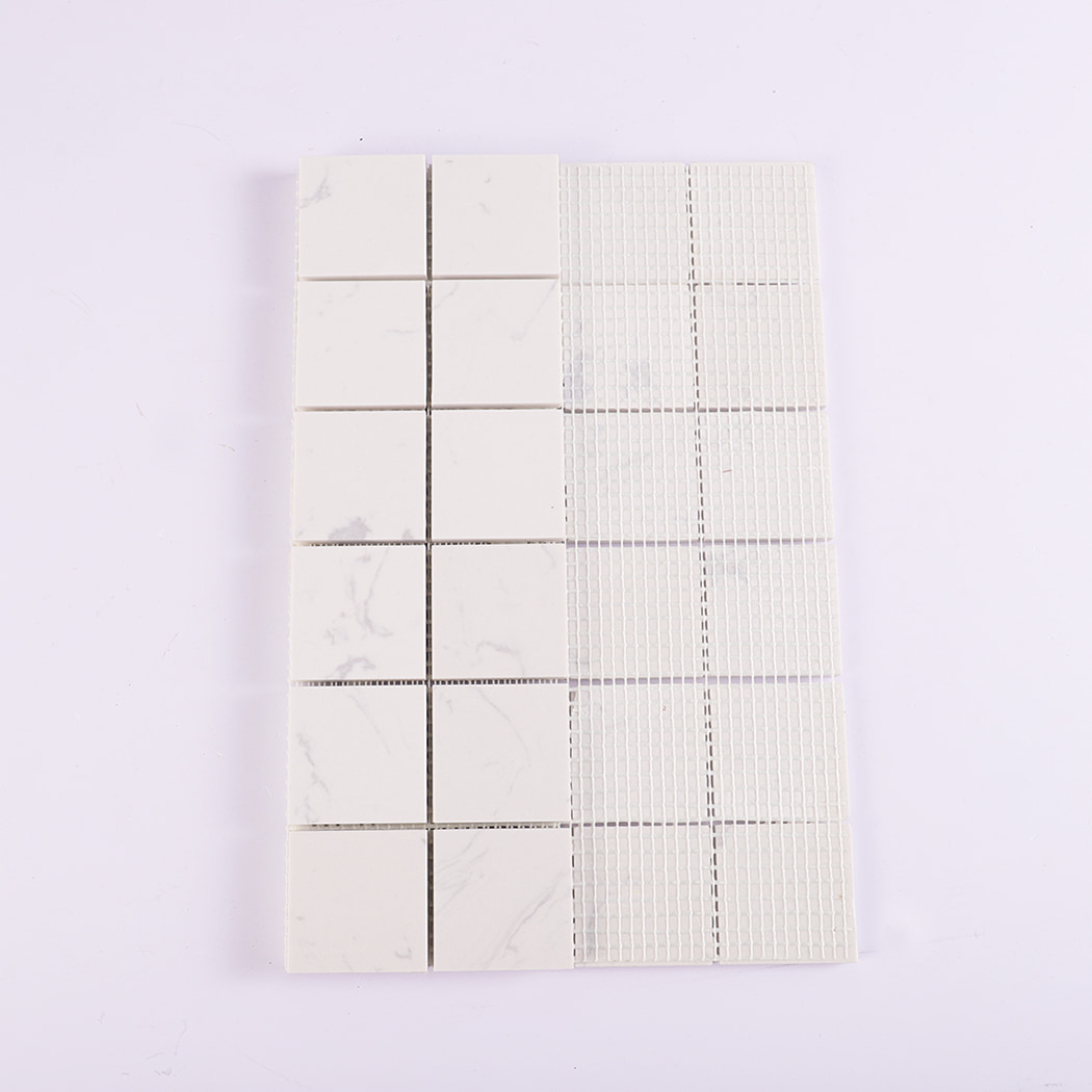 Back view showing mesh backing of white engineered marble mosaic tiles.
