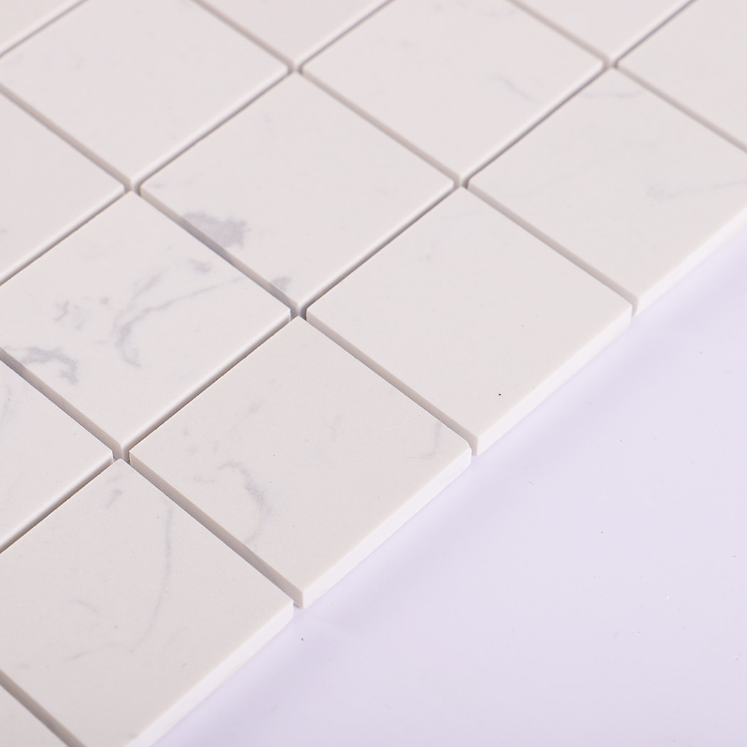 Side view of white engineered marble mosaic tile showing tile thickness.