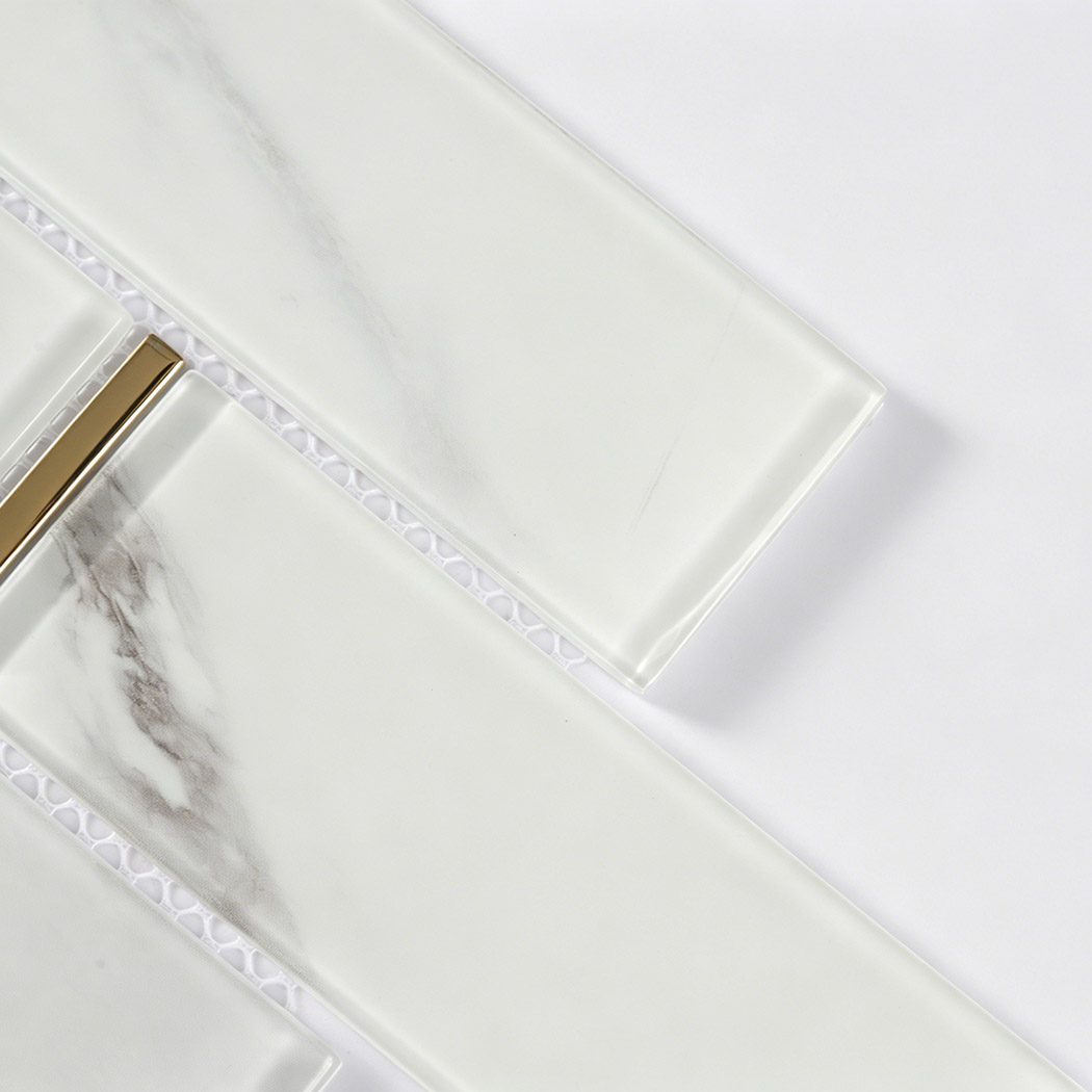 White marble glass subway tile detail with beveled edges and metallic gold accent