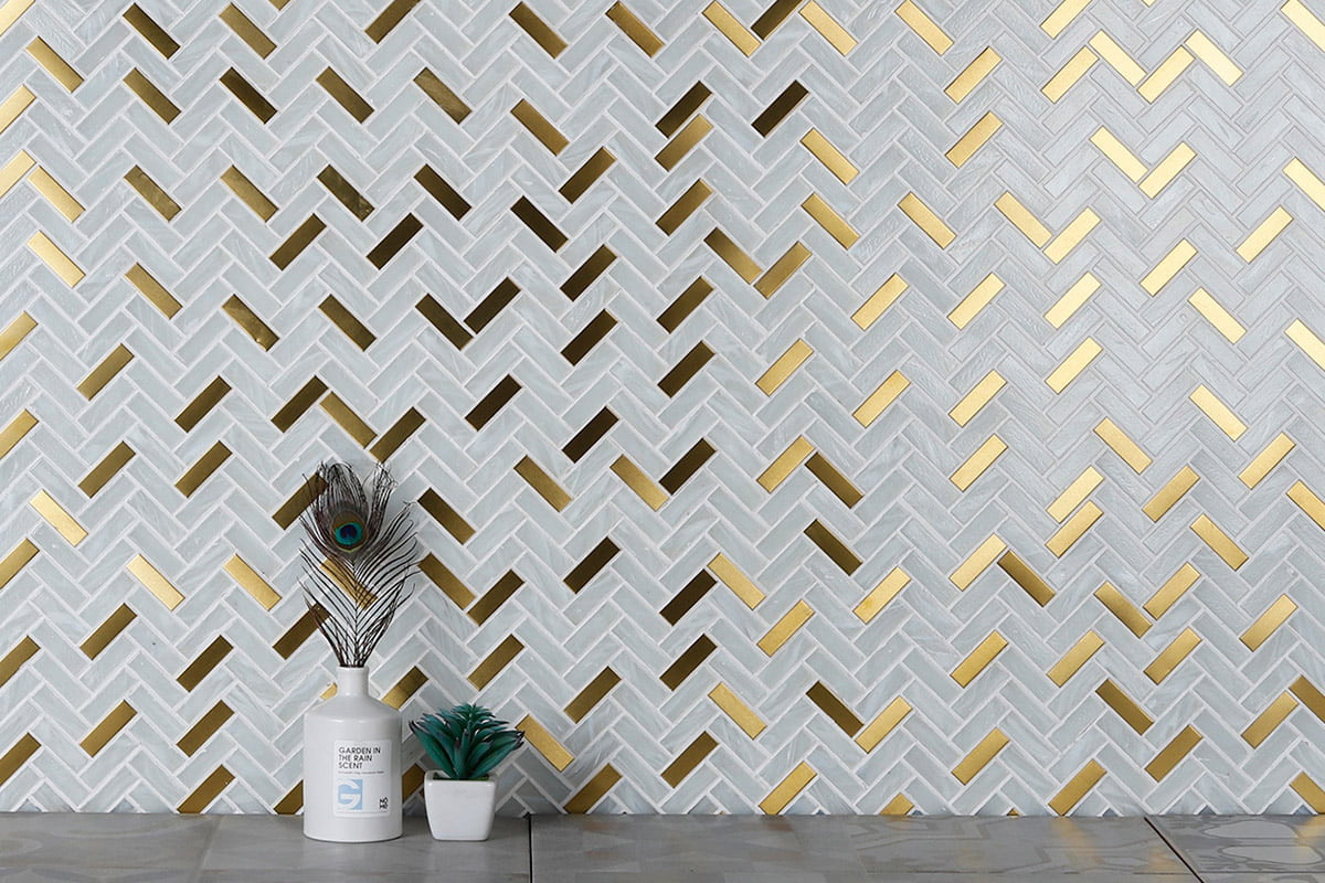 White and gold herringbone tile backsplash pattern