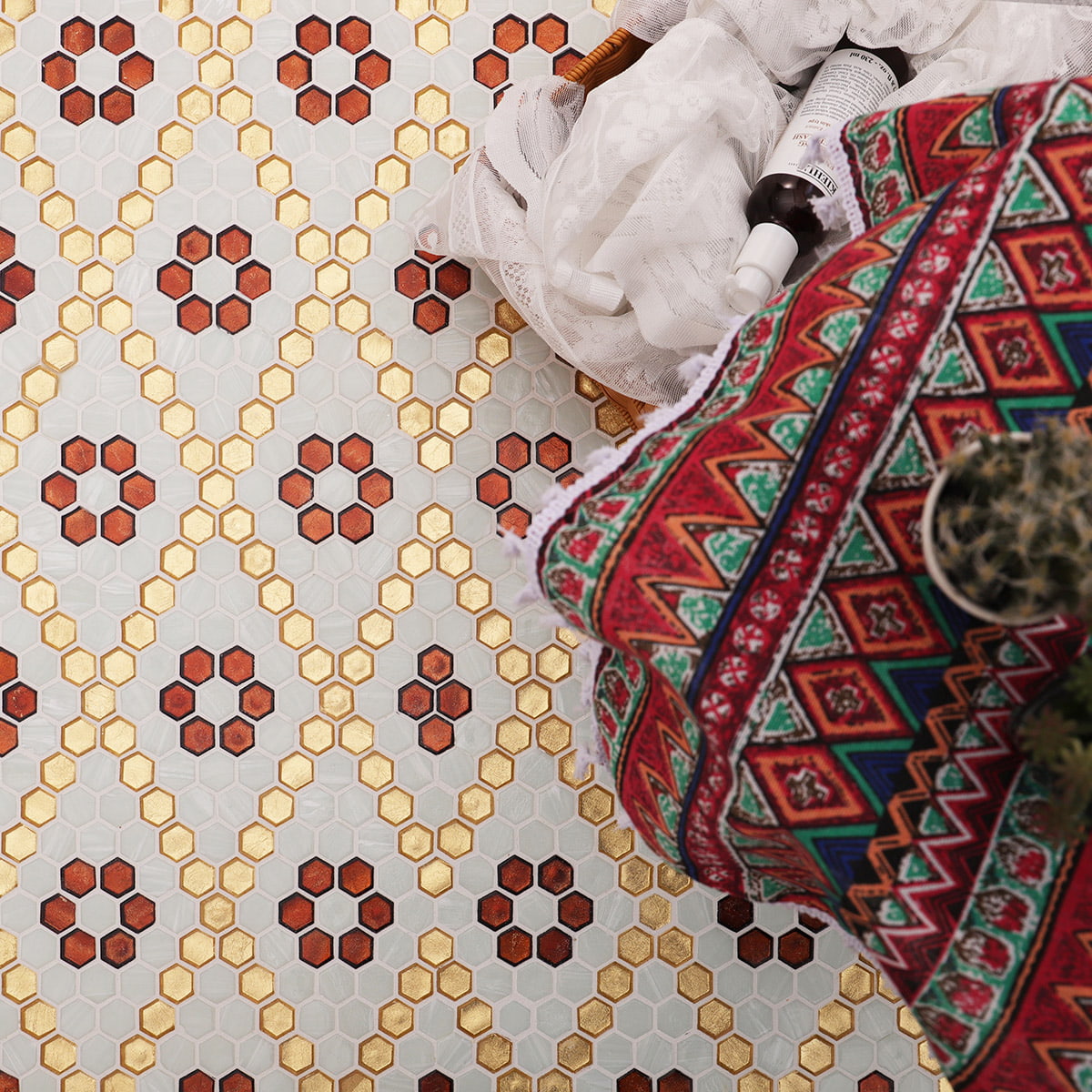 White and gold hexagon glass mosaic tiles with floral layout and props