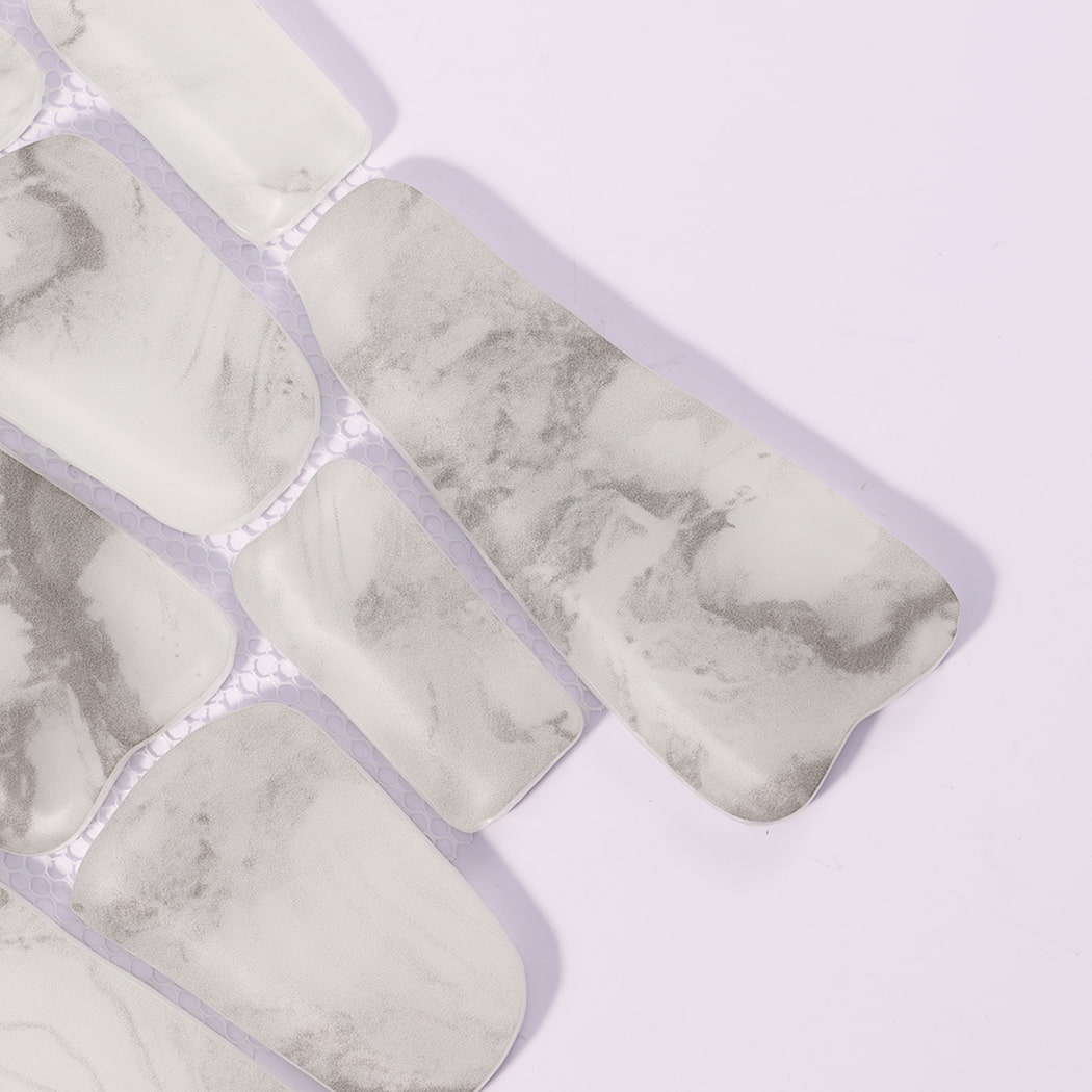 Close-up of white gray irregular glossy glass mosaic tile pieces