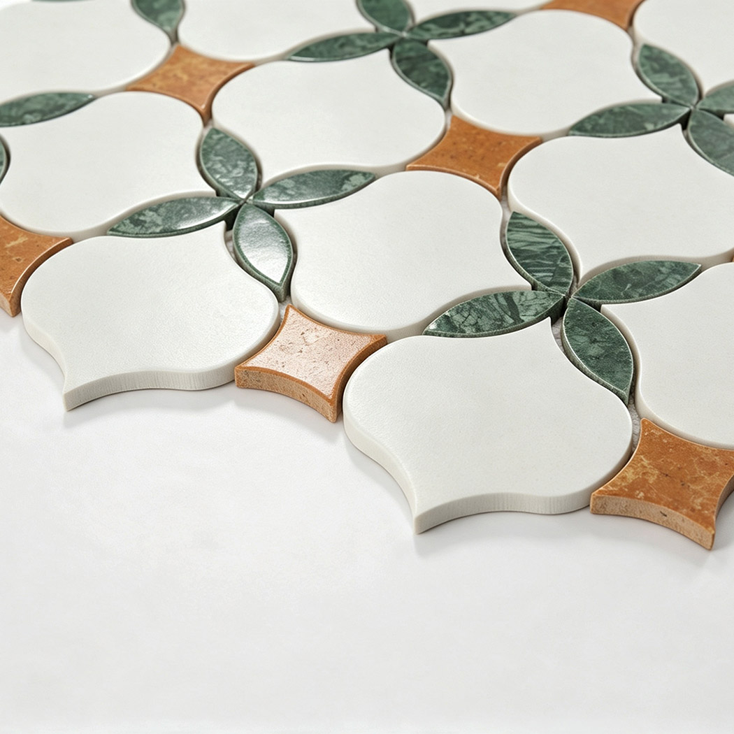 Angled view showing white arabesque marble mosaic with green leaves and orange accents