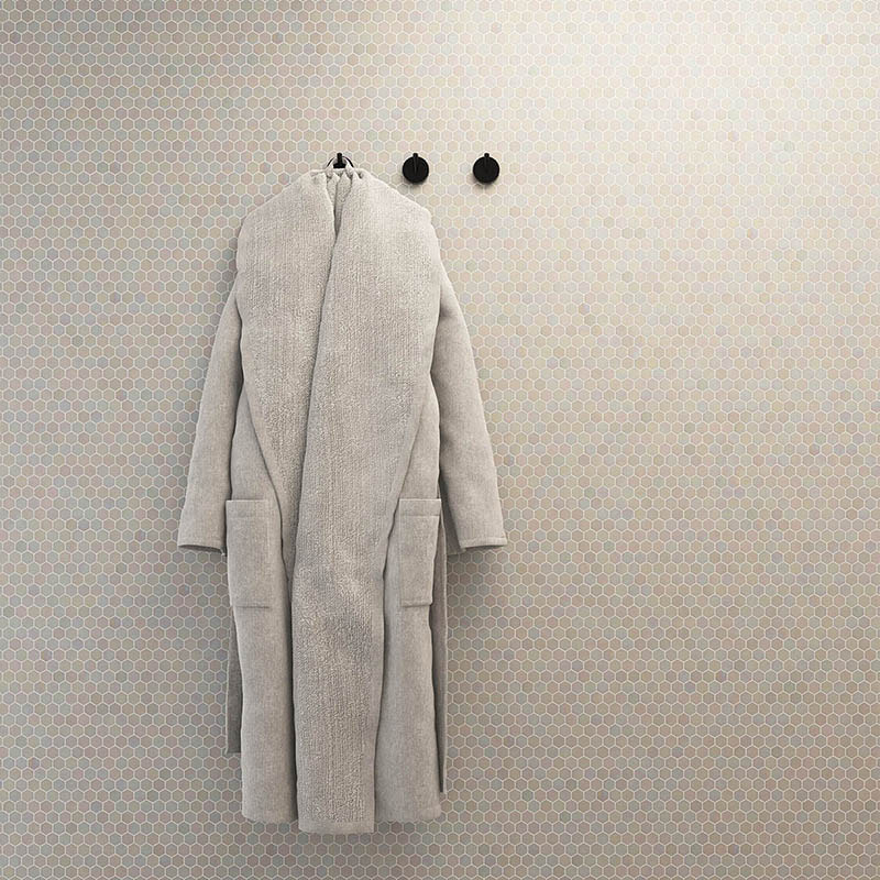 White iridescent hexagon tile wall with hanging coat