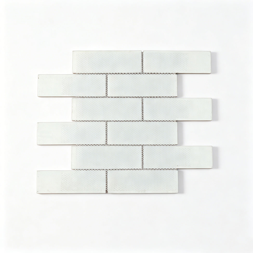 Back view showing the clean white interlocking mesh backing of the brown glass tile sheet.