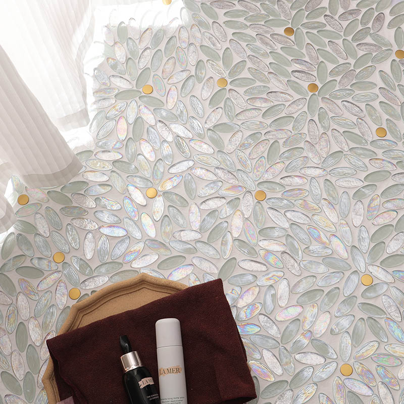 White iridescent flower mosaic tile floor with gold dots in a styled interior scene