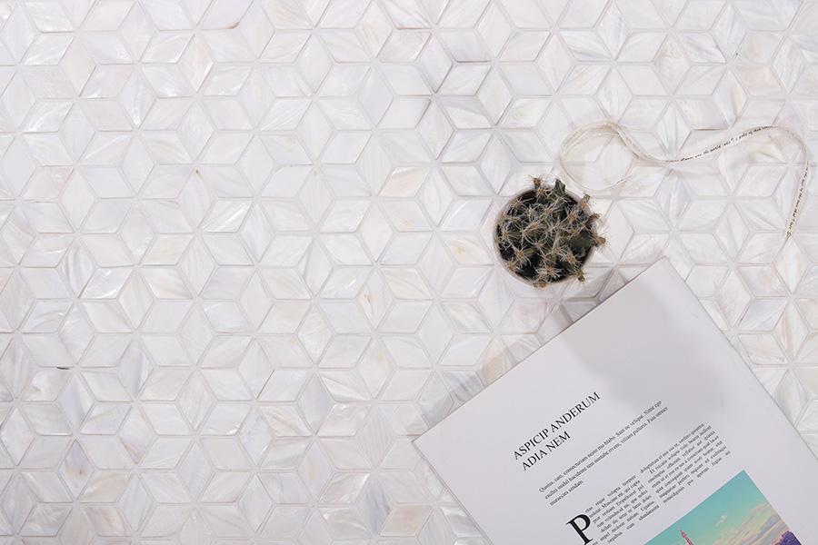 White kitchen tiles in a geometric shell star pattern with a natural pearlescent glow.