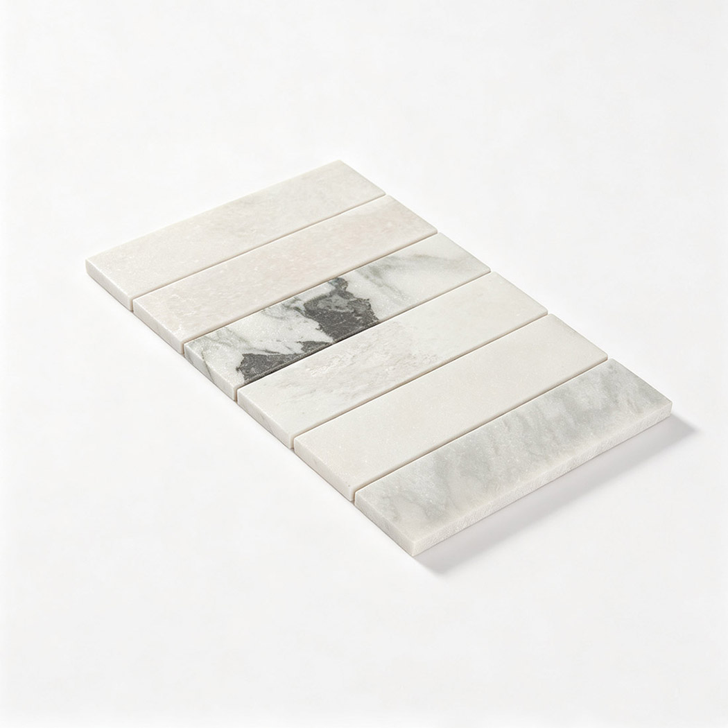 Angled view of a white linear marble mosaic sheet with natural gray veining