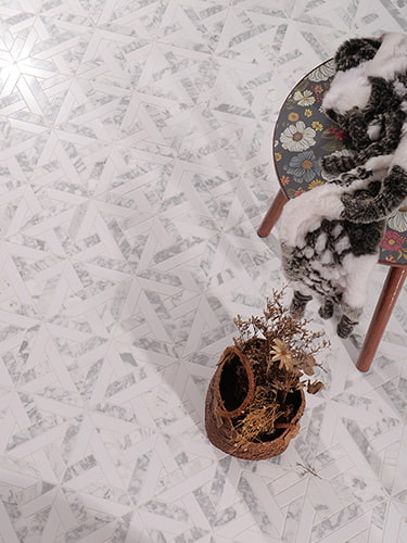 Top view of white marble floor with star-like geometric design