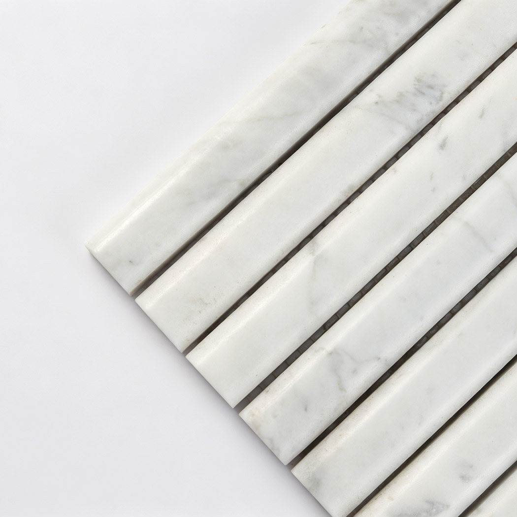 Close up of white marble fluted rod mosaic tile showing natural veins and polished surface