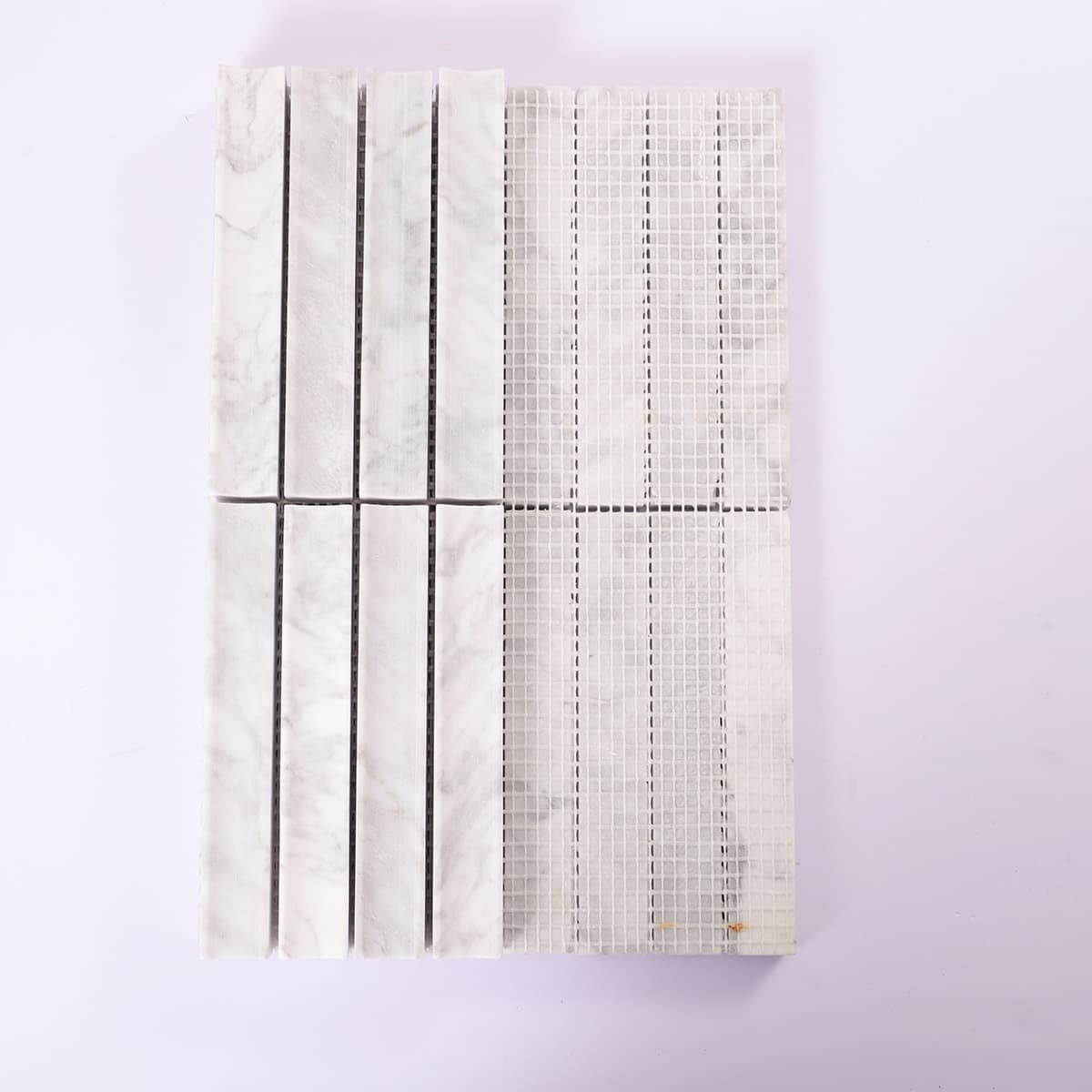 Back view of white marble tile sheet with mesh backing