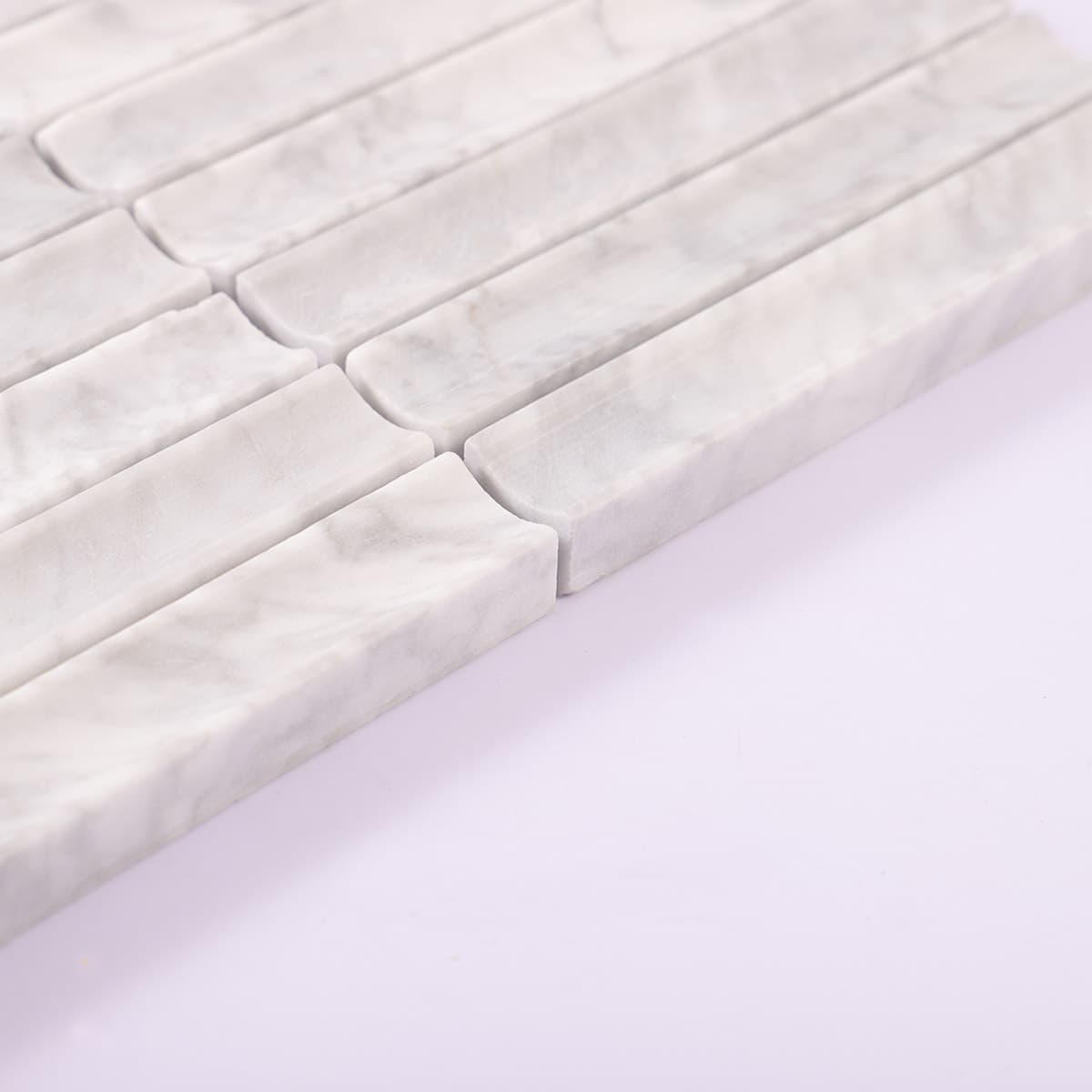 Edge view of curved white marble mosaic strips